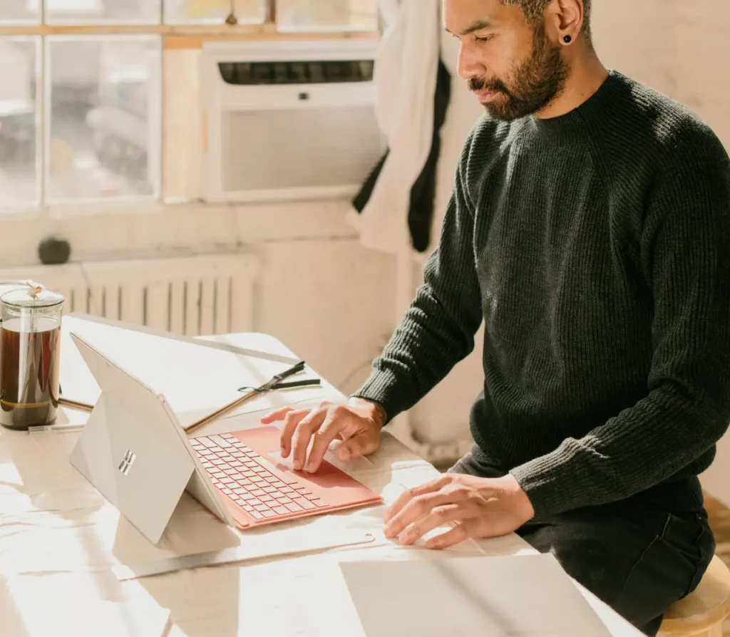 Image d'un homme entrain de travailler sur un ordinateur portable
